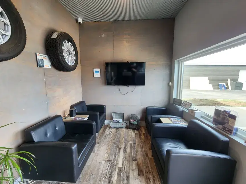 Customer waiting room with leather seating, TV and tire displays