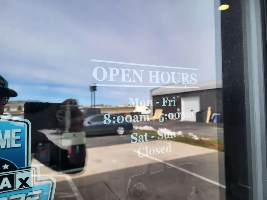 Front door decal listing open hours: Monday through Friday, 8:00am to 5:00pm
